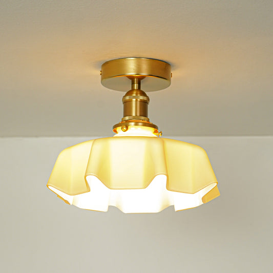 Closeup of amber glass and gold metal ceiling light for luxury home decor and traditional interior styling spaces.