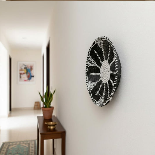 Round wall decor in dark tone mounted along hallway wall enhancing contemporary home styling with artistic and elegant appeal.