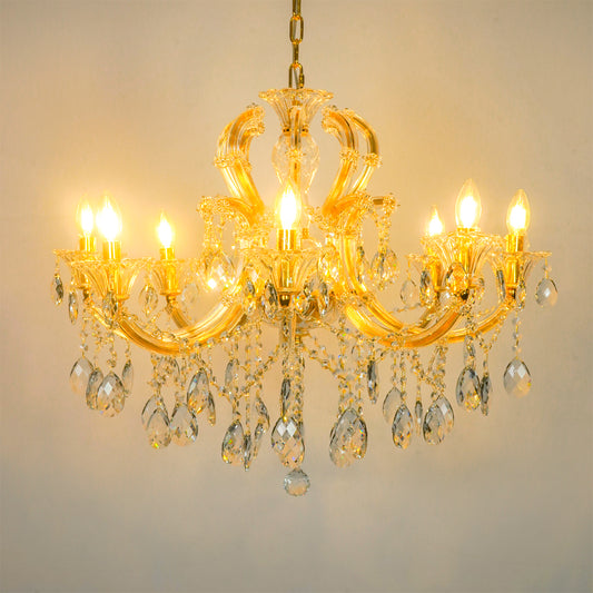 White background image of large gold metal candle style chandelier for modern living room decor styling with a bright warm glow.