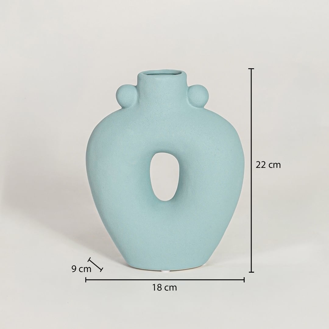 Light blue ceramic sculpted loop vase measuring 22 cm height 18 cm width and 9 cm depth perfect for contemporary home styling.