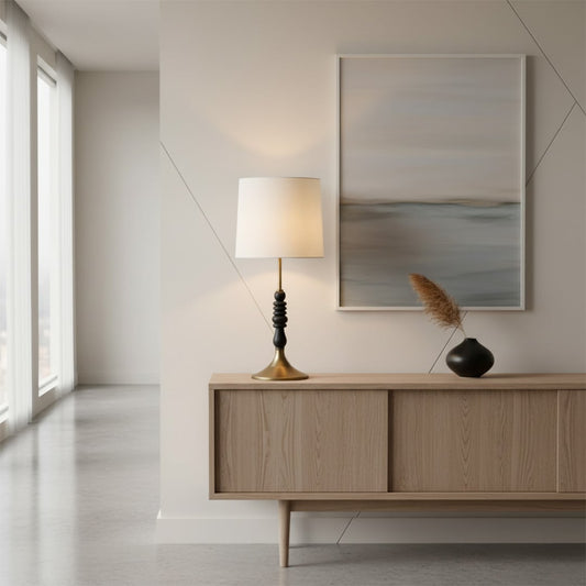 Contemporary table lamp featuring a white fabric shade black stacked decorative base and metal stand offering warm ambient illumination for interior home decor.
