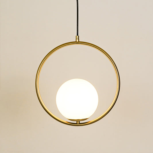 Gold metal ring pendant light with opal glass globe for modern interiors on white background image.