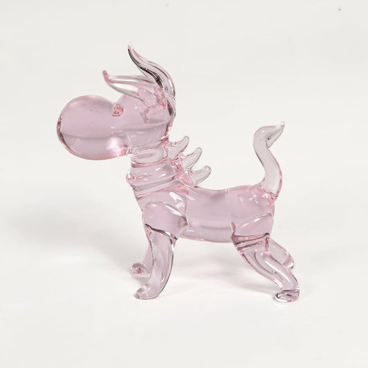 Pink glass dog figurine with glossy transparent finish isolated on white background for playful and cute decor display.