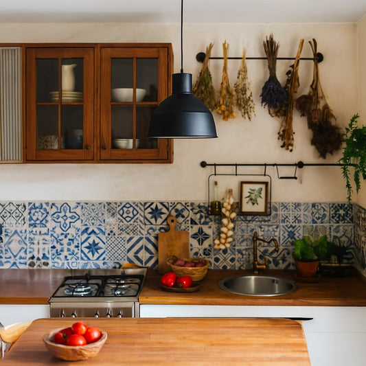 Modern matte black dome pendant light hanging over a wooden kitchen island with blue patterned wall tiles for rustic decor.
