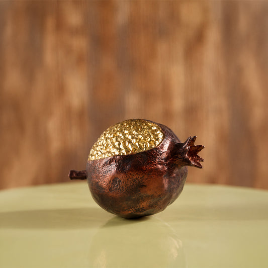 Gold and brown decorative pomegranate sculpture for artistic tabletop styling and contemporary home decor displays.