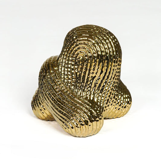 Contemporary gold metal statement decor sculpture with sculpted pattern for luxury interiors.