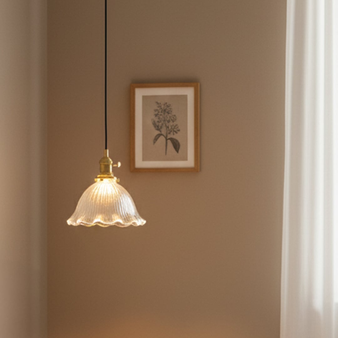 Ribbed clear glass and brass metal pendant light creating cozy ambience in modern interiors.