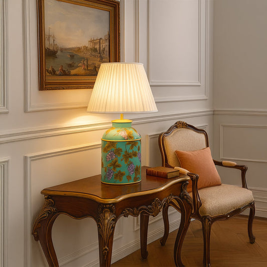 Palais mint green ceramic table lamp with pleated cream shade styled on wooden console creating elegant and artistic home lighting.