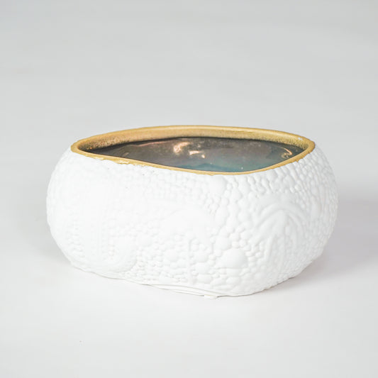 White textured ceramic bowl with gold rim for elegant dining table placement and modern decor styling centerpiece.