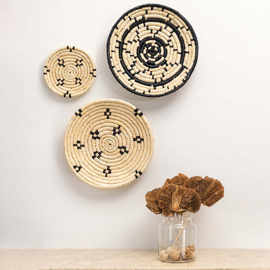 Set of natural woven decorative wall baskets with artistic patterns for elegant wall styling and bohemian home decor.