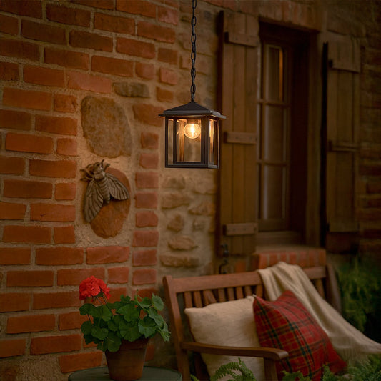 Elegant black metal outdoor hanging lantern with clear glass panels adding warm ambient lighting to patios and entryways.
