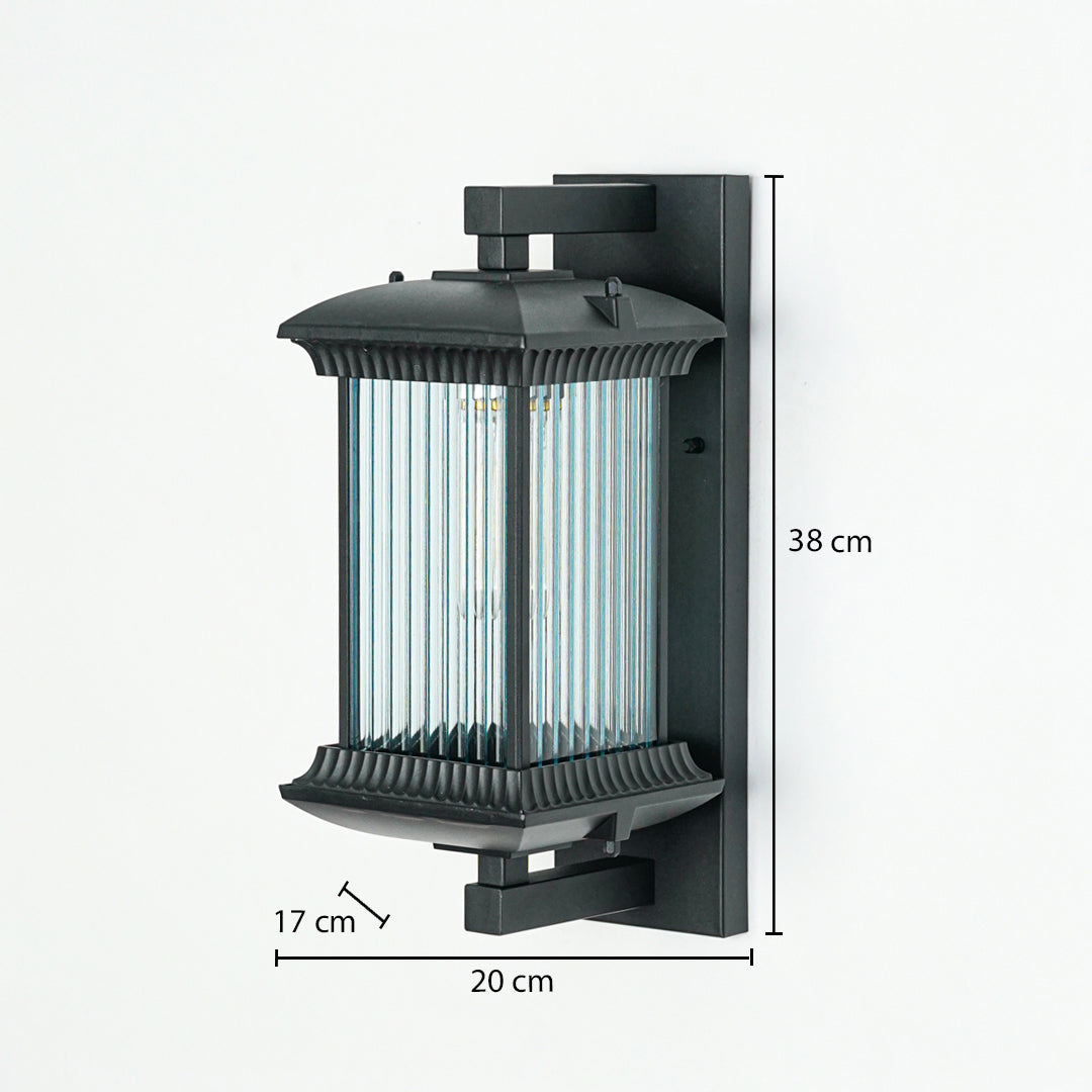 Outdoor wall light with black metal frame and ribbed glass enclosure mounted on wall 38 cm height 20 cm width 17 cm depth perfect for exterior lighting.