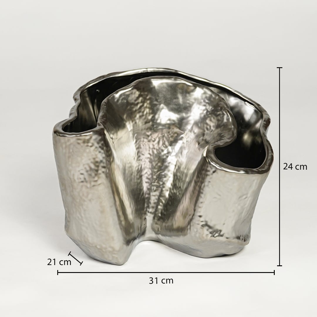 Silver metal decorative vase measuring 24 cm height 31 cm width and 21 cm depth ideal for modern table decor styling.
