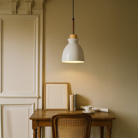White pendant light with wooden accent hanging above study desk for modern home office and dining room interior lighting.