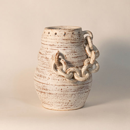 Decorative ceramic vase in off white finish with sculpted handle details for table decor or shelf styling contemporary home placement white background.