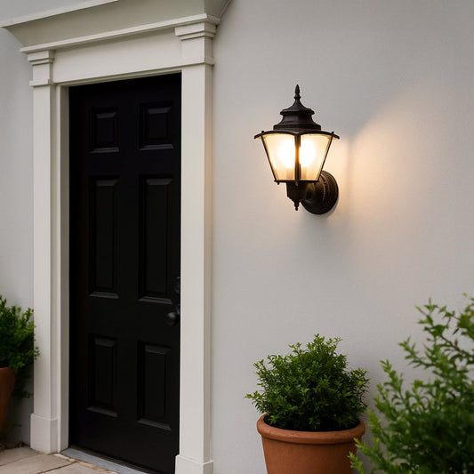 Black metal outdoor wall lantern mounted on exterior wall adding classic ambient lighting to porch gate and balcony Decor.