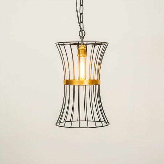 A hanging pendant light with a black wire cage shade and a warm glowing Edison bulb, accented by a gold metal band and cap, suspended against a plain off-white background.