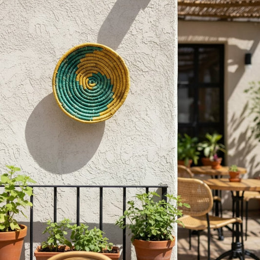 Colorful woven wall basket mounted on exterior wall above plants creating artistic focal point for balcony and patio Decor.