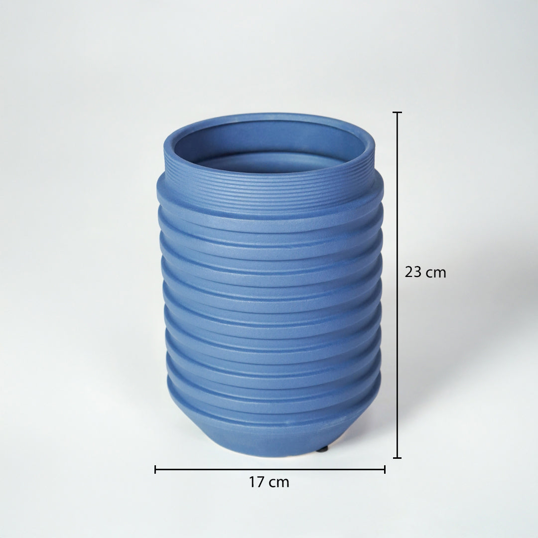 Matte blue ribbed cylindrical vase with clear dimension markings for modern minimalist home decor catalog use.