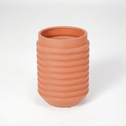 Terracotta ribbed ceramic planter pot for modern coffee table placement and elegant indoor decor styling accent.