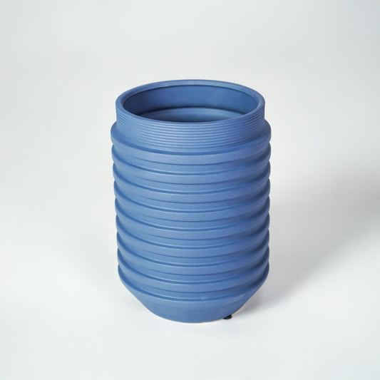 Blue ceramic ribbed planter vase for modern tabletop decor styling with elegant matte finish on white background.