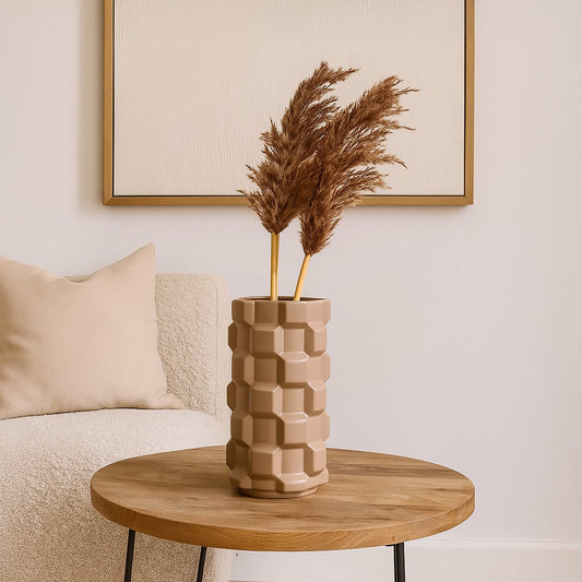 Brown geometric ceramic vase styled in a modern interior perfect for consoles shelves and elegant contemporary home decor accents.