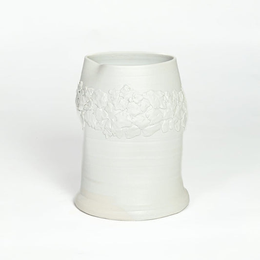 White ceramic decorative vase with embossed floral band isolated on white background for elegant tabletop decor placement.