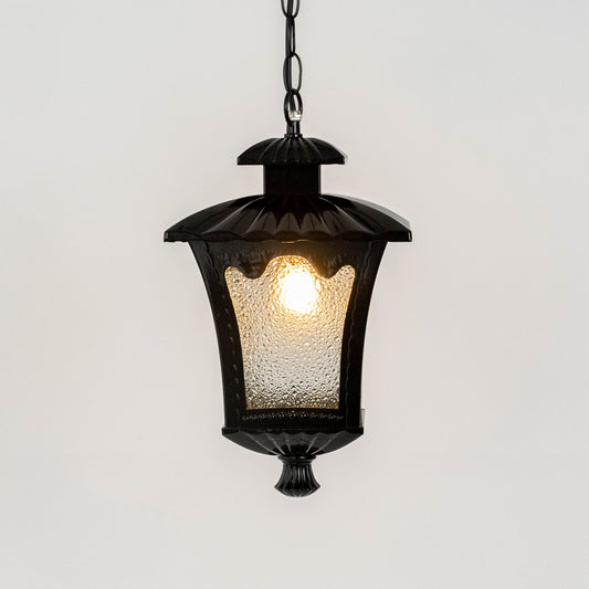 Vintage black metal hanging lantern light with warm glow and textured glass for elegant porch decor.