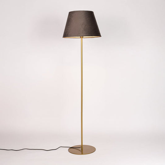 Gold metal floor lamp with dark grey fabric shade illuminated on white background for soft ambient living room lighting Decor.