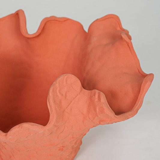 Closeup orange textured ceramic vase surface detail modern decorative flower vase for table shelf console decor.