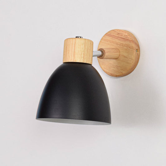 Unlit matte black metal wall sconce with natural wood details isolated on a clean white background showcasing its simple bell shape design.
