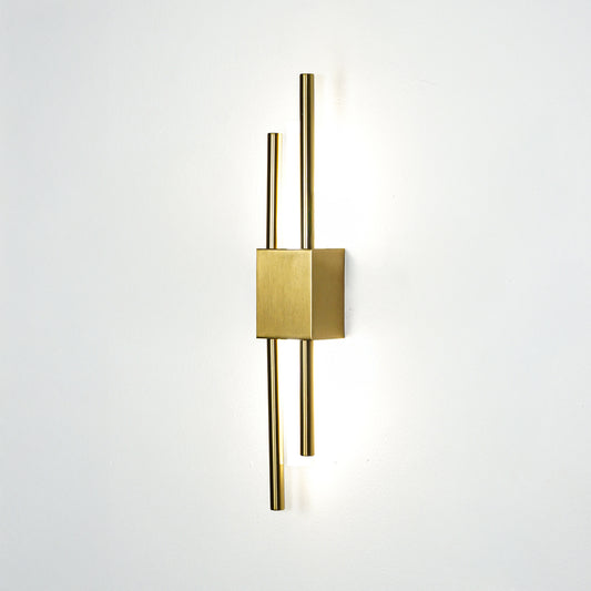 Elegant gold metal wall light glowing on white wall for modern bedroom hallway and luxury interior decor styling.