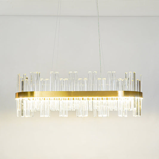 Modern crystal linear wall light with gold metal base and vertical glass rods mounted on clean white wall background for luxury interior lighting.