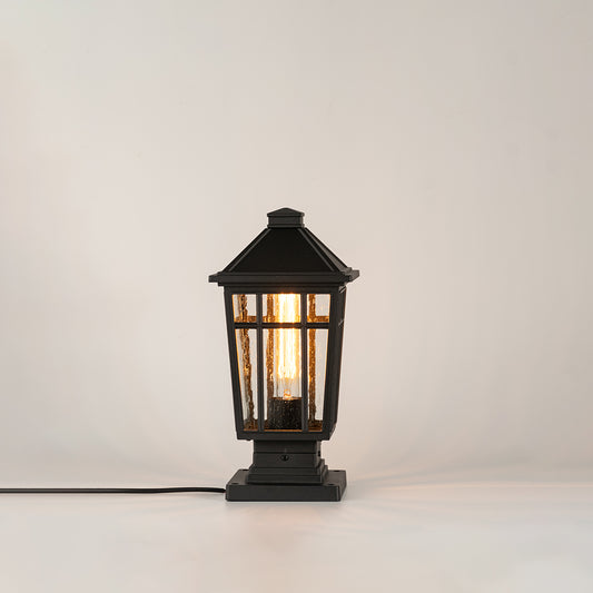 Modern black outdoor gate light with warm glowing bulb for elegant exterior decor styling use.
