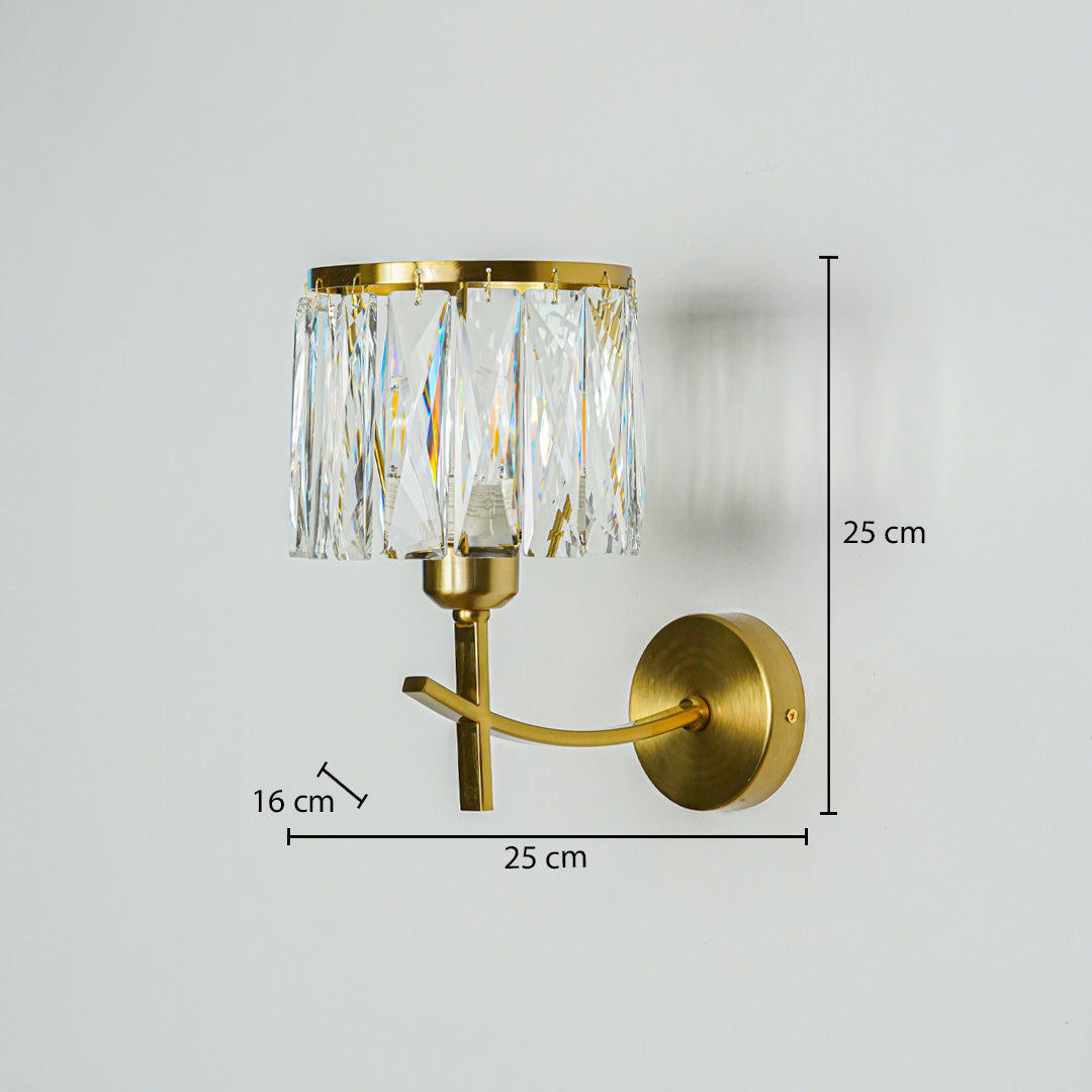 Luxury gold wall light with crystal glass shade mounted on neutral wall background 25 cm height 25 cm width 16 cm depth ideal for elegant interior decor lighting.