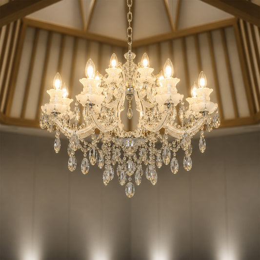 Lifestyle image of large gold metal candle style chandelier for luxury living room decor styling with elegant crystal detailing.