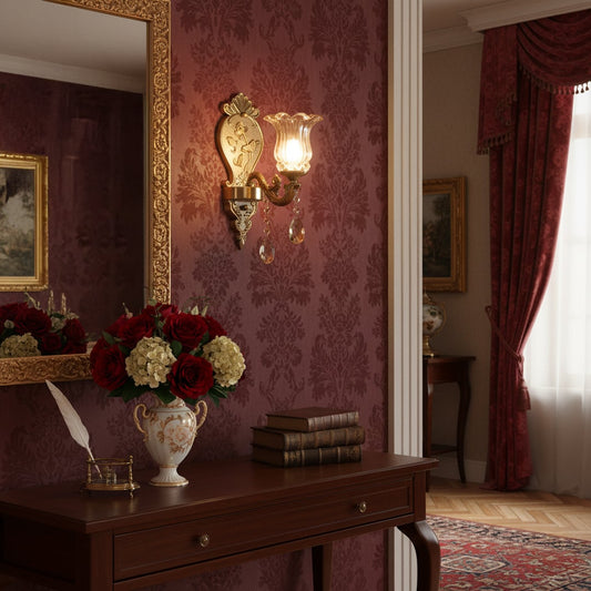 Wall light with antique gold metal frame and amber glass shade styled on a soft wall background for warm elegant home lighting.