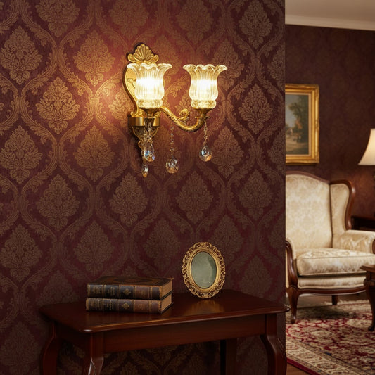 Wall light with antique gold metal frame and amber glass shades styled on a soft wall background for warm elegant home lighting.