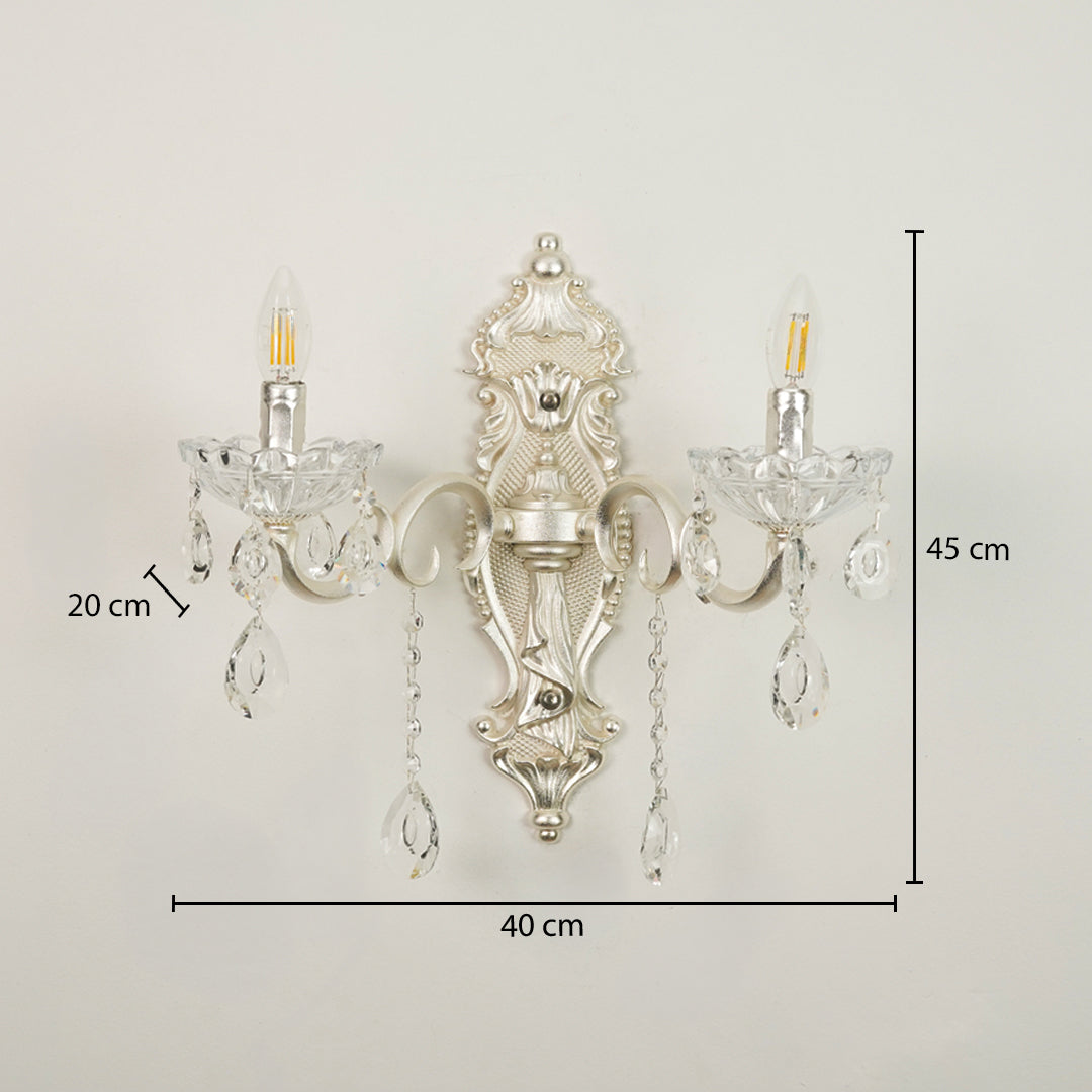 An ornate silver wall sconce with two clear crystal candle-style bulbs and hanging crystal drops, shown against a plain light background with dimension labels indicating 40 cm width, 45 cm height, and 20 cm bulb/crystal spacing.