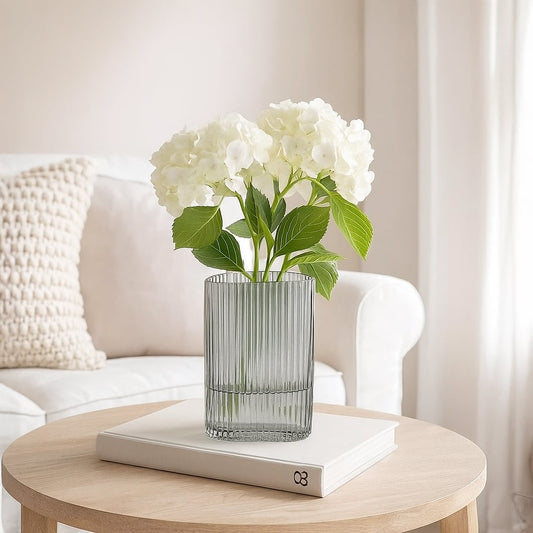 Ribbed grey glass vase styled on a modern tabletop with soft lighting adding an elegant accent to contemporary home interiors.