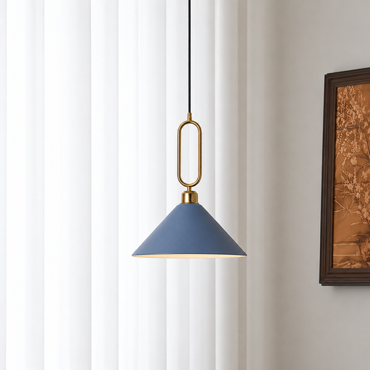 A modern pendant light with a blue-gray cone shade, a gold metal loop, and a black cord, hanging in front of white vertical blinds next to a framed picture.
