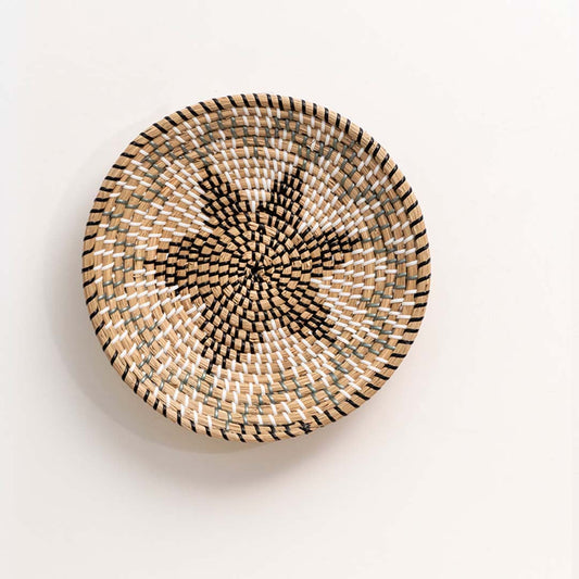 Natural handcrafted woven wall basket with floral star design for artistic wall styling and contemporary home decor.