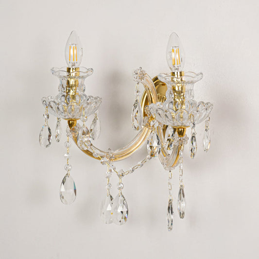 Gold crystal wall light with detailed glass arms shown on white background for premium interior decor inspiration.