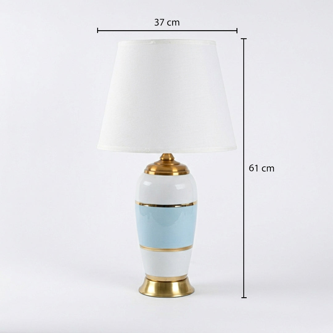 Table lamp with white fabric shade on white background minimal modern lighting suitable for bedroom and study decor.