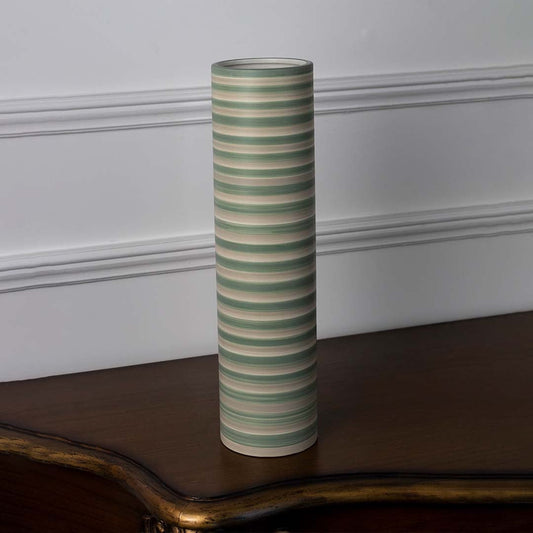 Tall striped ceramic vase in green and beige tones displayed on a clean white background highlighting its smooth cylindrical design.