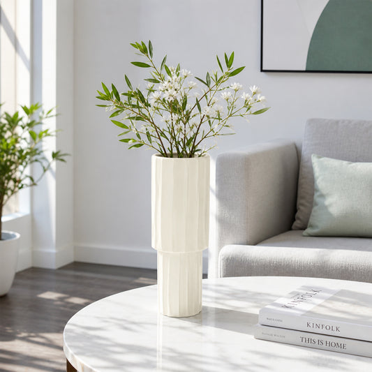 Cream ceramic flower vase with white blooms placed on marble table for elegant modern home decor styling.
