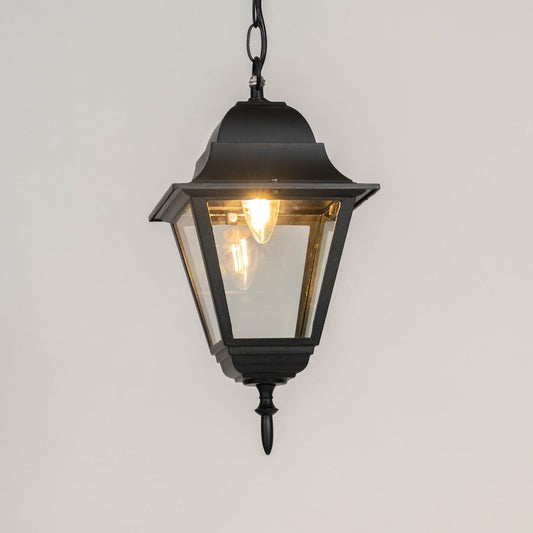 Modern black metal hanging lantern light with warm glow and clear glass for elegant outdoor decor.