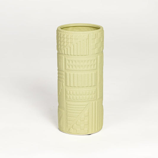 Yellow ceramic textured cylindrical vase with carved geometric detailing isolated on white background for contemporary home decor use.