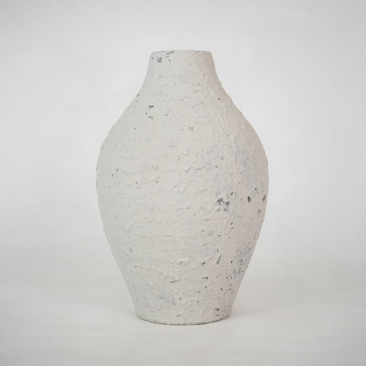 Minimalist textured white speckled ceramic vase for elegant modern home decor and refined interior shelf styling.