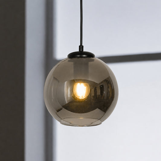 Smoked glass pendant light glowing softly with black fittings for stylish modern interiors.